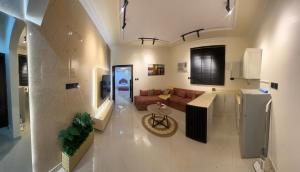 a large living room with a couch and a kitchen at شقه in Hail