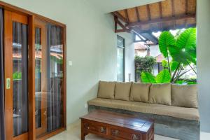 a living room with a couch and a table at Warsa's Garden Bungalow and Spa in Ubud