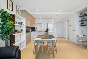 a kitchen and dining room with a table and chairs at FLEMINGTON - Melbourne City Views in Melbourne