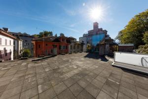 an empty street with buildings and the sun in the sky at WELCOME APARTMENTS - Luzern in Lucerne