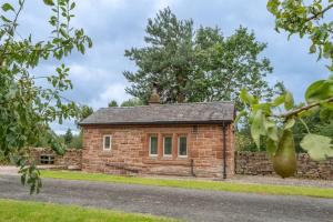 a small brick building on the side of a road at The Railway Weigh Office (Cliburn) in Penrith