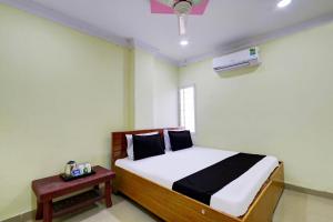 a small bedroom with a bed and a window at SPOT ON Al Nizam Guest House in Hyderabad