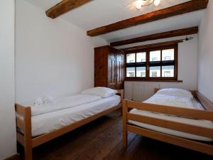 a bedroom with two beds and a window at Scenic Apartment in Uttendorf with Private Terrace in Uttendorf