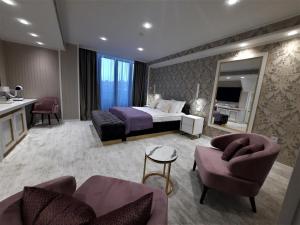 a hotel room with a bed and a mirror at Queen Palace in Novi Sad