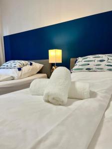 a hotel room with two beds with towels on them at bloom: See Berge moderne Ausstattung für 2-6 Pers in Tegernsee