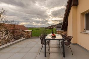 a patio with a table and chairs on a balcony at Apartment Tati in Dol pri Ljubljani