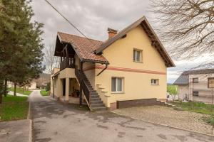 a small house with a staircase in front of it at Apartment Tati in Dol pri Ljubljani