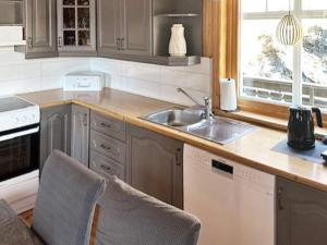a kitchen with a sink and a counter top at Three-Bedroom Holiday home in Selje 1 in Selje