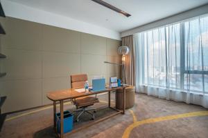 an office with a desk and a chair and a window at Four Points by Sheraton Changchun Hi-Tech Zone in Changchun +34 photos