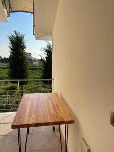 una mesa de madera en un balcón con vistas en Garden Villa Sunny, en Tale