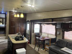 a kitchen and living room of an rv at Entire 1bedroom RV Camper in Fort Pierce