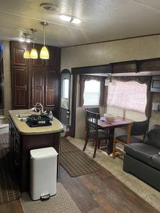 a kitchen and dining area of an rv at Entire 1bedroom RV Camper in Fort Pierce