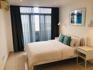 - une chambre avec un grand lit et une fenêtre dans l'établissement Luxurious 2 Bedroom Apartment @Embassy Garden, à Accra