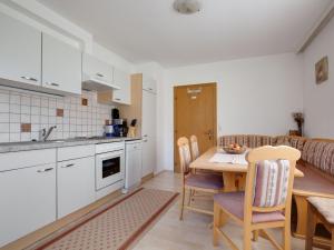 a kitchen and dining room with a table and chairs at Upscale Apartment in Salzburg with terrace and country views in Hollersbach im Pinzgau