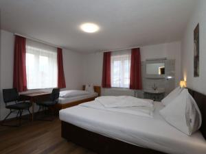 a hotel room with two beds and a desk at holiday home Bergheim F gen in Fügen