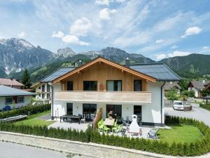 a house with mountains in the background at Modern Holiday Home in Leogang with Private Sauna in Leogang