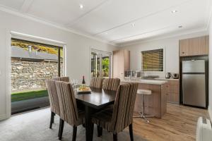 a kitchen and dining room with a table and chairs at Valley Villa - Cardrona Holiday Home in Cardrona