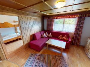 a living room with a purple couch and a bed at Chalet in Neukirchen in Neukirchen am Großvenediger