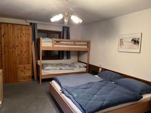 a bedroom with two bunk beds in a room at Large holiday apartment for groups in Lengdorf near Niedernsill in Niedernsill