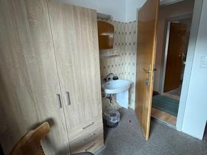 a small bathroom with a sink and a cabinet at Large holiday apartment for groups in Lengdorf near Niedernsill in Niedernsill