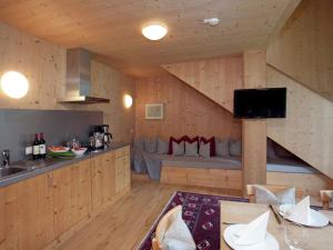 a kitchen with a couch in the middle of a room at Apartment in Ramsau im Zillertal with sauna in Ramsau im Zillertal