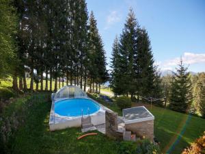 a swimming pool in a greenhouse in a yard at Apartment in Fresach near Millstättersee with pool in Fresach