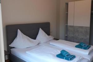 two white beds with towels on top of them at Beautiful and Cosy Flat in Wagrain in Wagrain