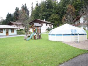 a playground with a slide and a tent at Scenic Apartment in Krispl Salzburg with Swimming Pool in Krispl
