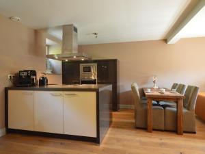 a kitchen and dining room with a table and a counter at Stunning Holiday Home near Forest in Slenaken in Slenaken