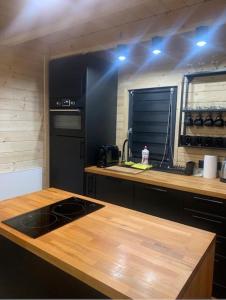 a kitchen with a wooden counter top with a stove at Srokowa Hacjenda in Krzyżowa