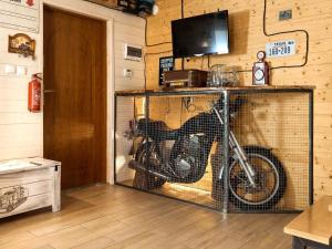 a bike in a cage in a room at Holiday home Biker's house in Nadole