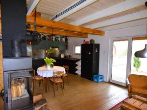 a kitchen and dining room with a table and a fireplace at Holiday home Biker's house in Nadole