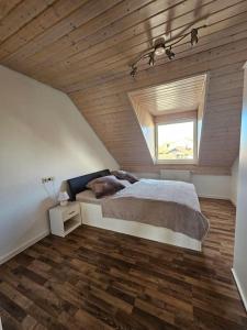 a bedroom with a large bed and a window at 2 Zimmer Wohnung in Bad Waldsee in Bad Waldsee