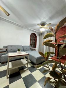 a living room with a couch and a table at Casa Madre Santa in Aguascalientes