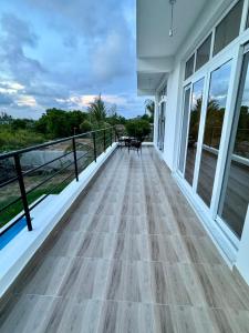 a balcony of a house with a wooden floor at Mich Homes in Malindi