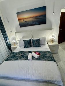 a bedroom with a large white bed with two pillows at Mich Homes in Malindi