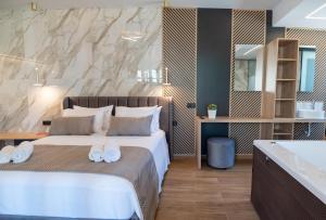 a hotel room with a bed and a bathroom at John & Mary Suites in Rethymno Town