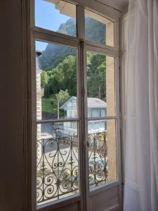 an open window with a view of a building at T3 de 70m2 5/7 couchages in Cauterets