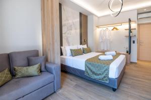 a hotel room with a bed and a couch at John & Mary Suites in Rethymno Town