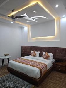 a bedroom with a large bed with avertisement at wooden suits in Ghaziabad