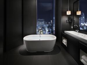 a bathroom with a bath tub and two sinks at Shinjuku Granbell Hotel in Tokyo +37 photos