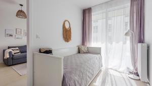 Postel nebo postele na pokoji v ubytování Apartamenty Sun & Snow Osada Cetniewo