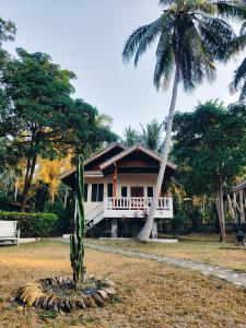 a house with a palm tree in front of it at MY HOME Resort - Koh phangan vacation house rentals in Ban Madua Wan