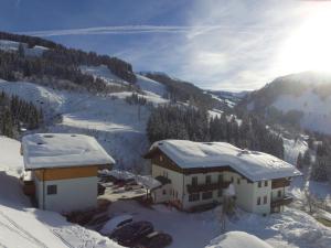 a building with snow on top of it at Modern Holiday Home in Maria Alm near Ski Area in Maria Alm am Steinernen Meer