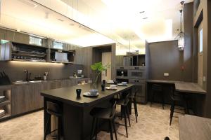 a large kitchen with a table and chairs in it at ST Signature Jalan Besar in Singapore