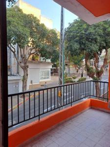a balcony with a view of a street and trees at Fellini Fortunella terrace (talpiot) in Haifa
