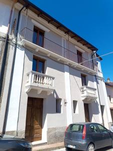 a white house with a car parked in front of it at Bed and Breakfast da Peppino in Bianchi