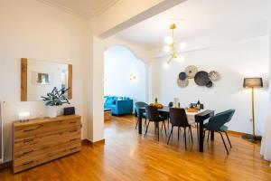 a dining room and living room with a table and chairs at Athens Luxury Getaway - Pasalimani City Oasis in Piraeus