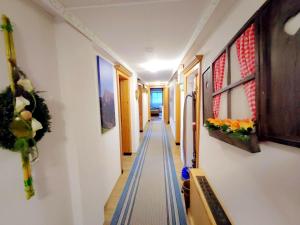 a long hallway with a blue and white stripe at Group Holiday Home in Hippach with dreamy views in Hippach