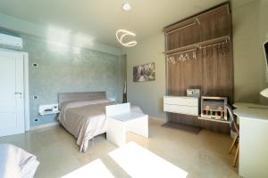 a bedroom with a bed and a desk and a tv at Villa Tito Livio StarGuest in Pozzuoli +54 photos